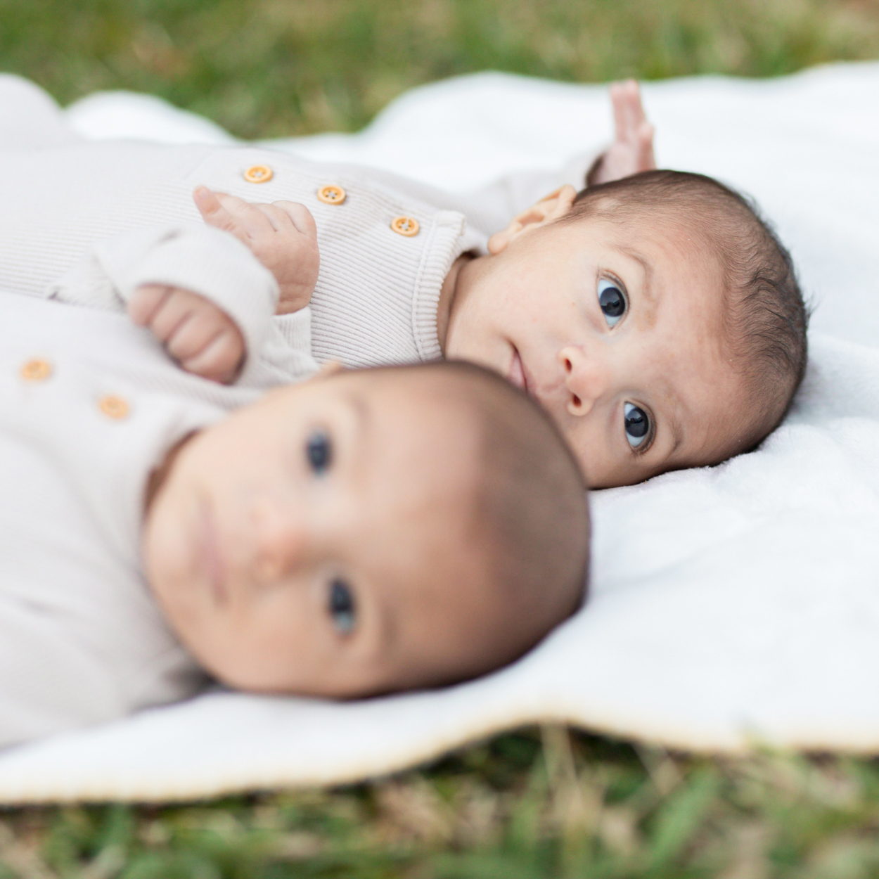 twin baby boys on a blanket